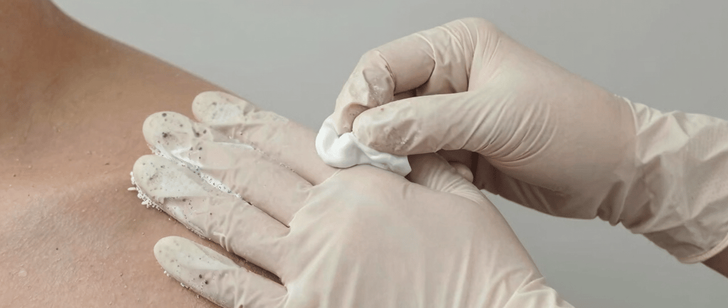 Close-up of nitrile gloves stacked neatly with a light blue background showing contrast and texture.