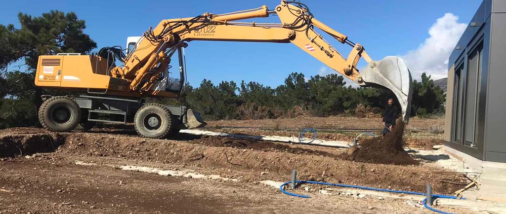 Excavation machine working in front of a house