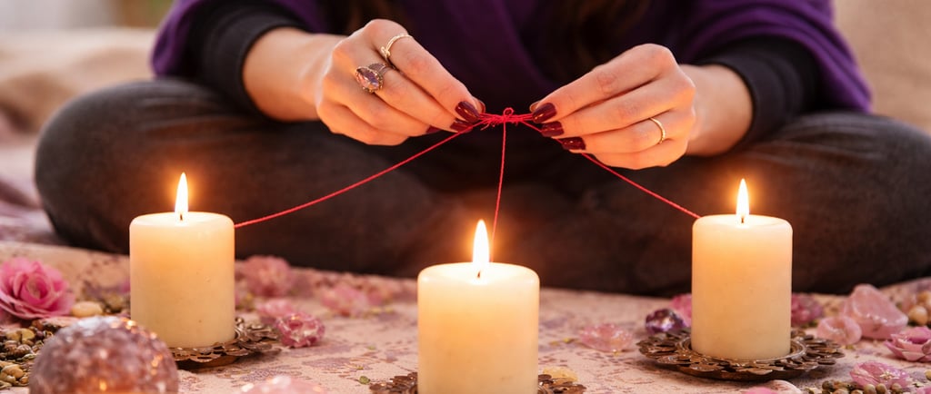 love spell ritual with candles and red thread knot
