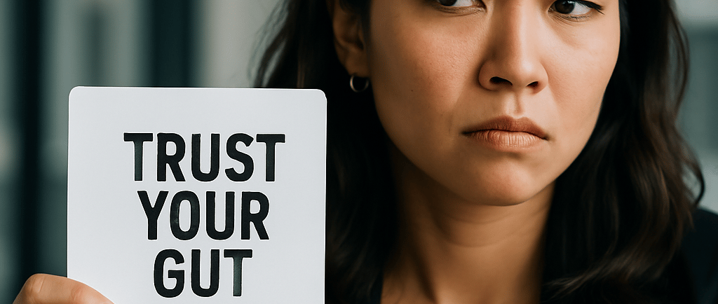 a woman holding a sign that says trust your gut