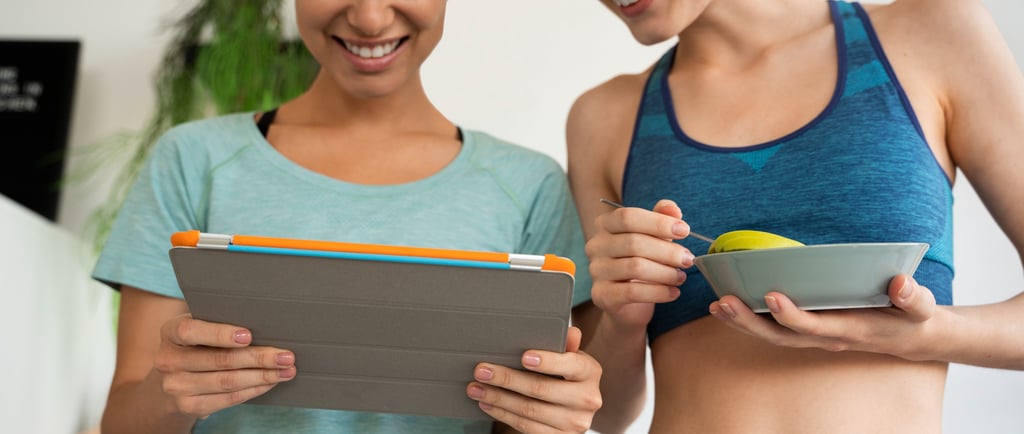 Two fitness women looking at ipad