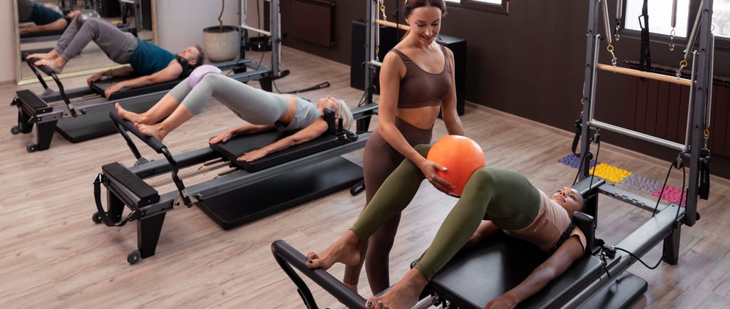 teacher in group pilates reformer class