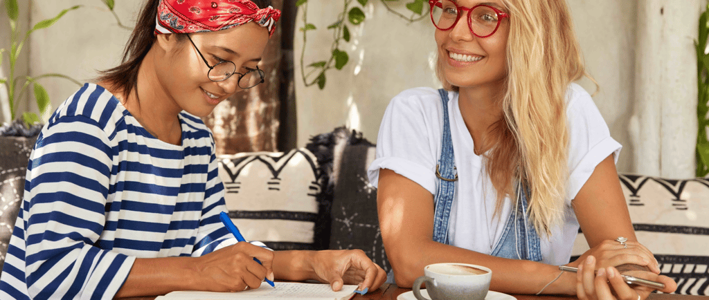 two women having a meeting in a coffee shop
