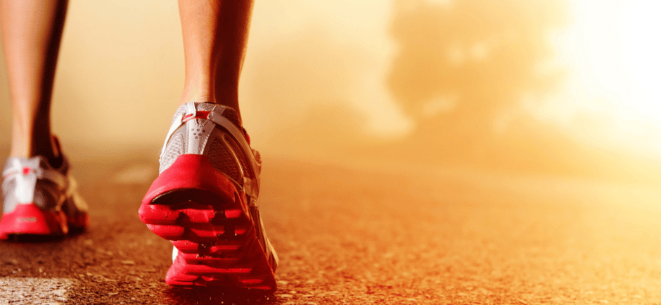 a person walking on a road with a red shoe