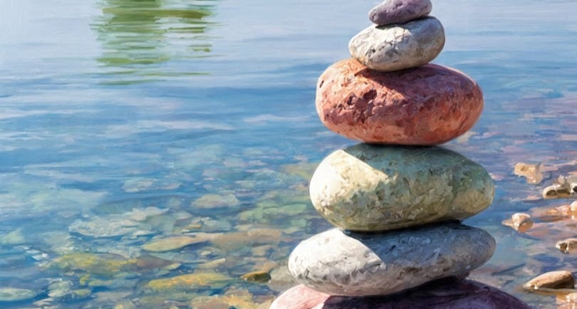 a stack of rocks sitting on top of a river