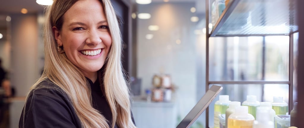 Smiling business owner with tablet in retail store
