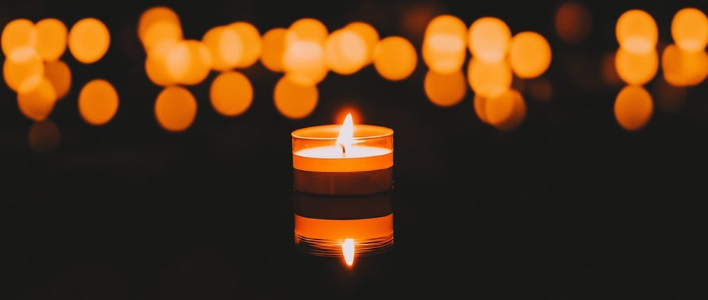 A candle with lights around it