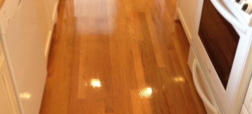"Cleaning hardwood floors in Daytona Beach, FL in a small office kitchen by TEC Floor Services."