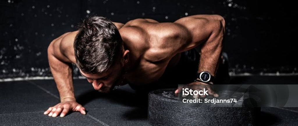 a man doing push-ups on a black background