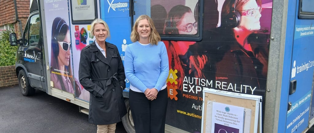 Two women standing in front of a Dementia Experience bus