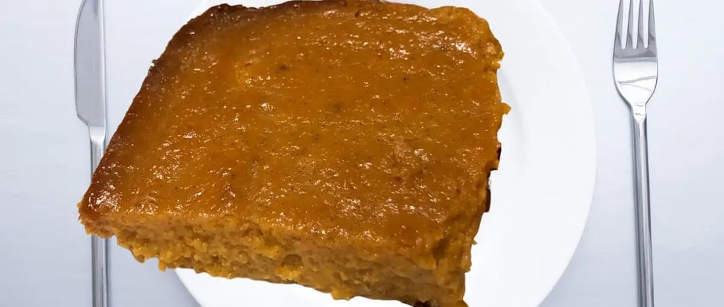 crustless sweetpotato pie hovering over white plate and fork and dinner knife