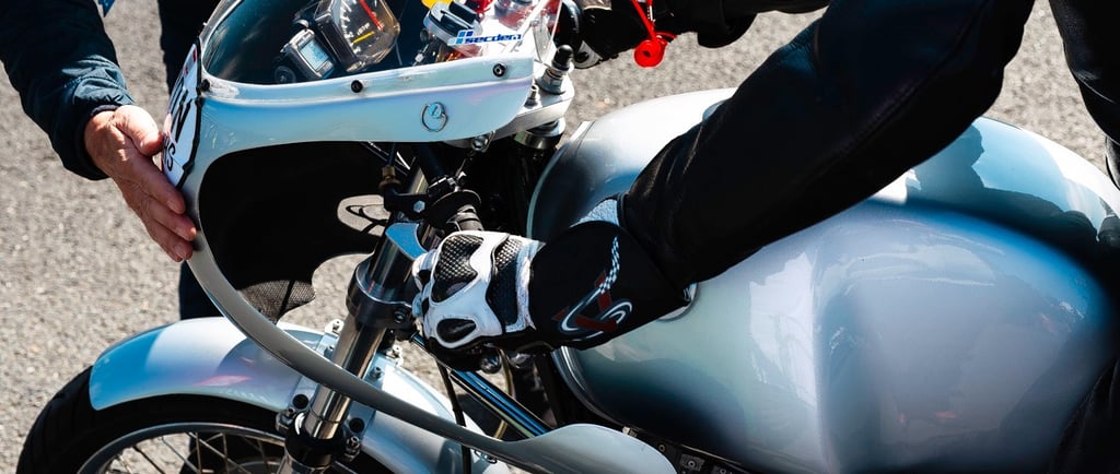 a person standing next to a motorcycle with a helmet on