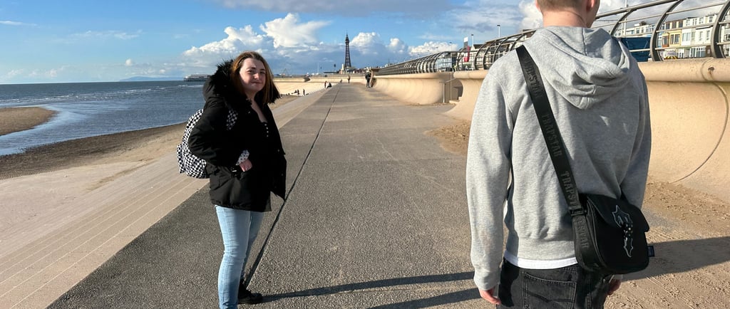a man and woman walking down a sidewalk
