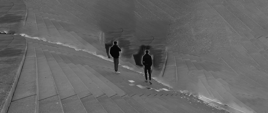 two people standing next to the beach