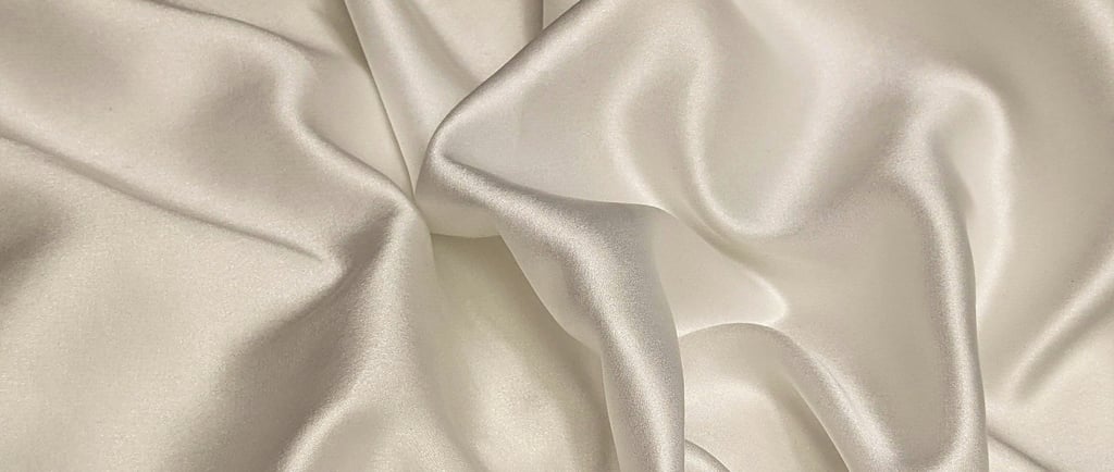a white satin and silk fabric with a satin finish