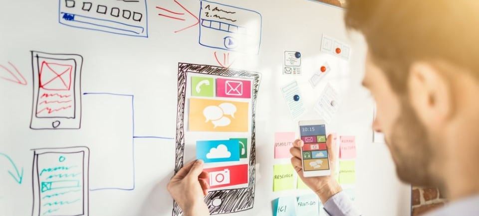 a man building a wireframe on a whiteboard