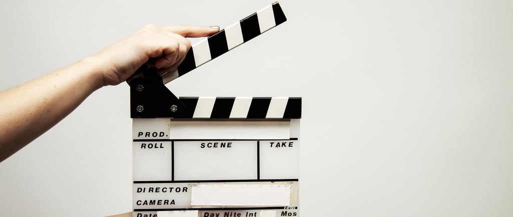 a person out of shot holding a clapper board