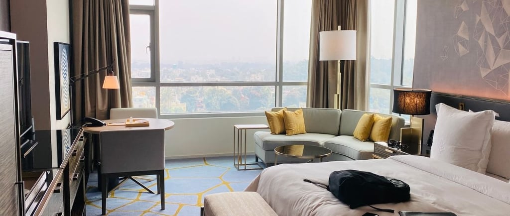 A hotel room with a couch and a television used for a blog titled AI hotel marketing