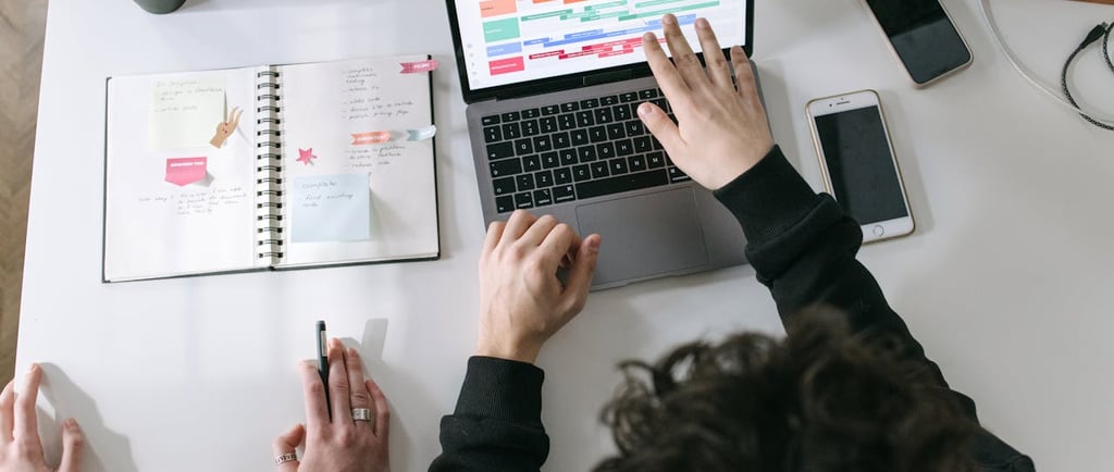 A product team analysing a project timeline displayed on a laptop 