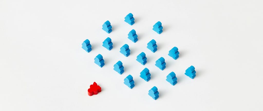 A red figure placed beside a group of blue figures