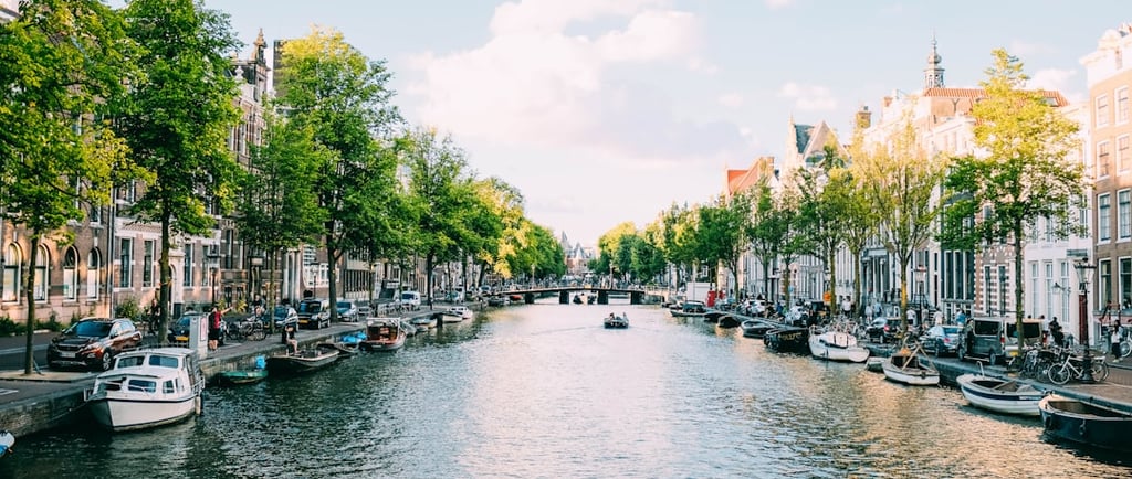 a canal with boats and people walking on it