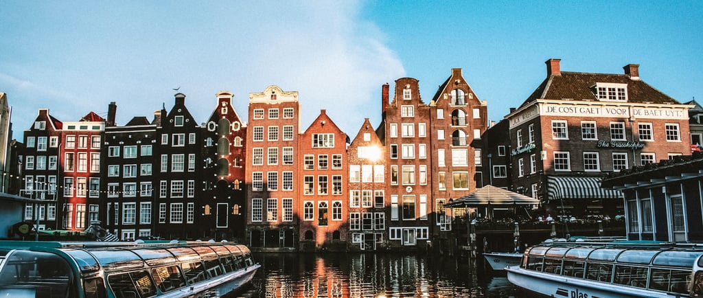 a boat on a river with buildings in the background