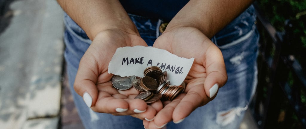 Woman holding a sign that says "make a change."