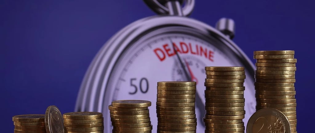 a clock with coins on a table