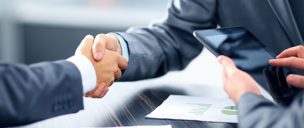 two men shaking hands with a tablet computer