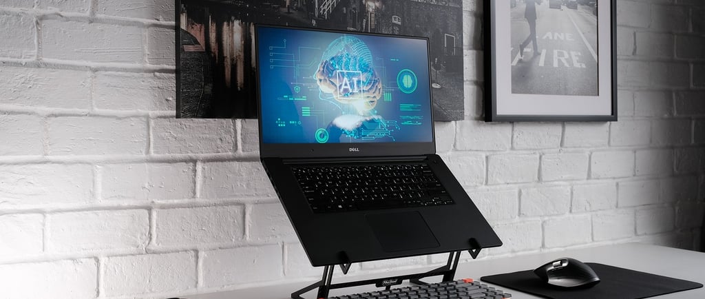 a laptop computer monitor and keyboard on a desk