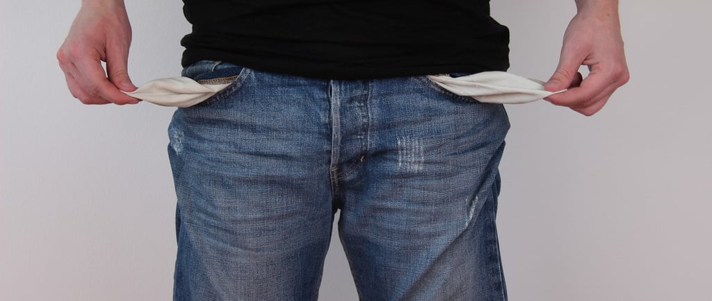 a man in a black shirt and jeans shorts, with empty pockets