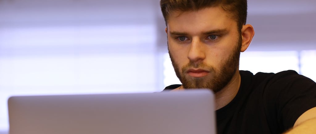 a man sitting at a laptop computer