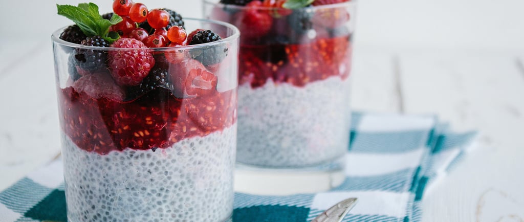 Chia seed pudding with mixed berries and a mint garnish