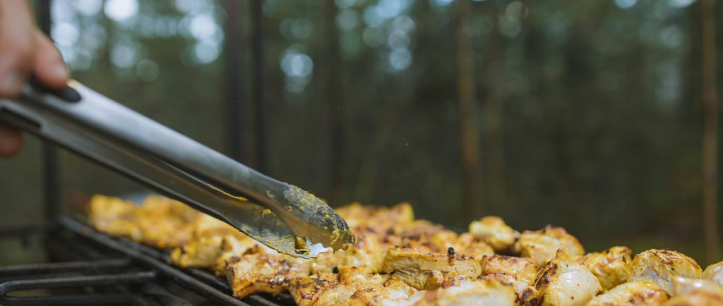 Chicken fillets being grilled outdoors