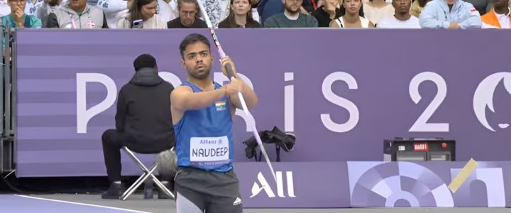 a man holding a pole pole in front of a crowd