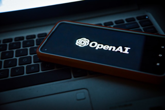 a cell phone with an open laptop on a laptop openai