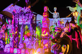 Extensive Halloween display at night using inflatables, lighting, and accessories.