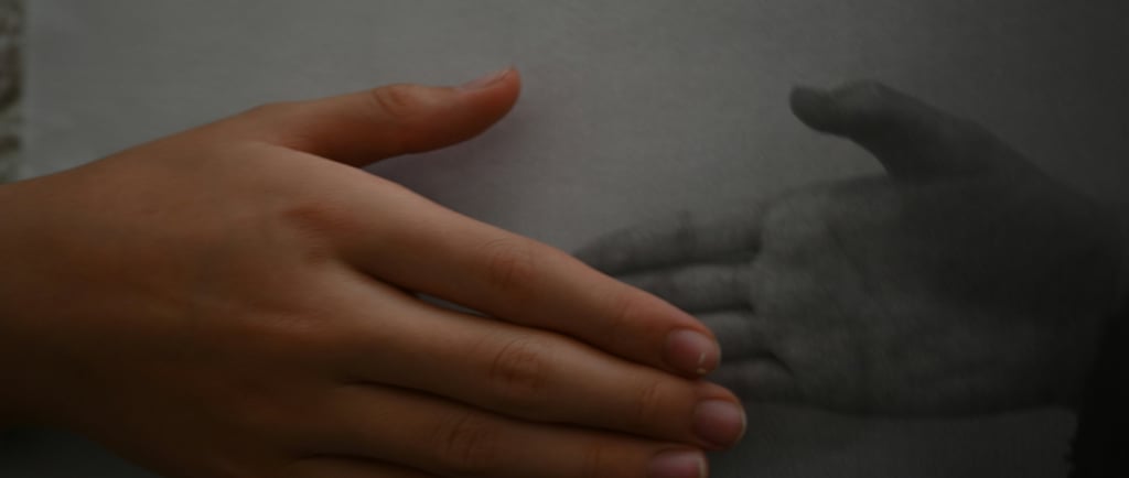 Close-up of two hands resting near each other, representing subtle emotional connection and safety