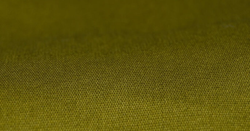 a close up of a green fabric covered table cloth