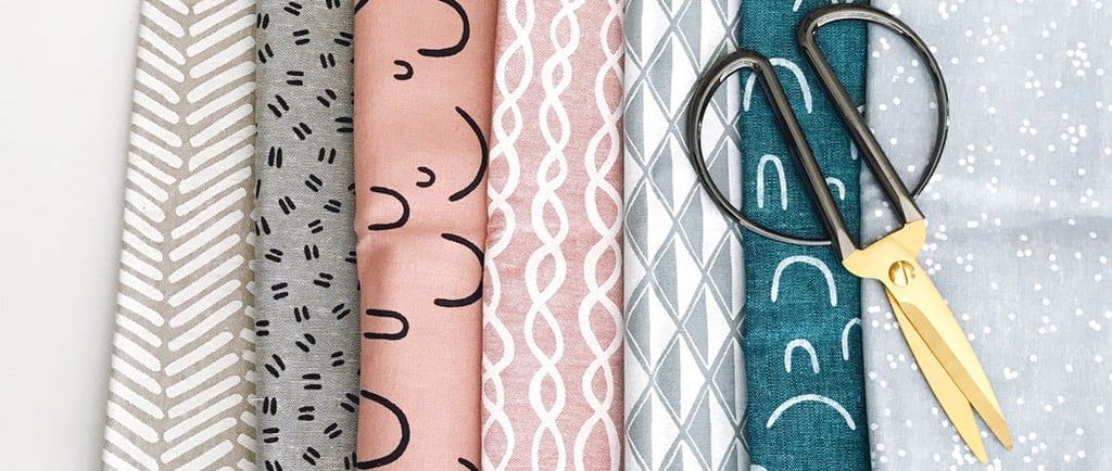 a bunch of fabrics and scissors on a table