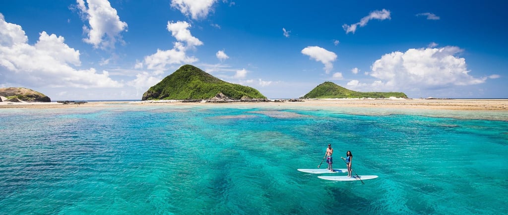 surfing in okinawa- picture of a couple surfing outside of okinawa island