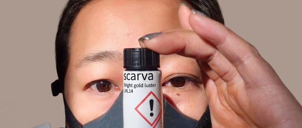 Studio safety: Wearing a respirator mask while holding Scarva gold luster.