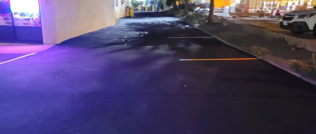 Sealcoated parking lot showing improved durability, restored color, and well-protected asphalt 