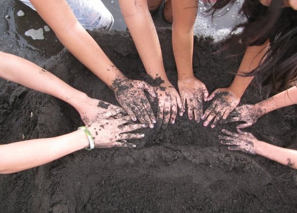 hands of children playing sand