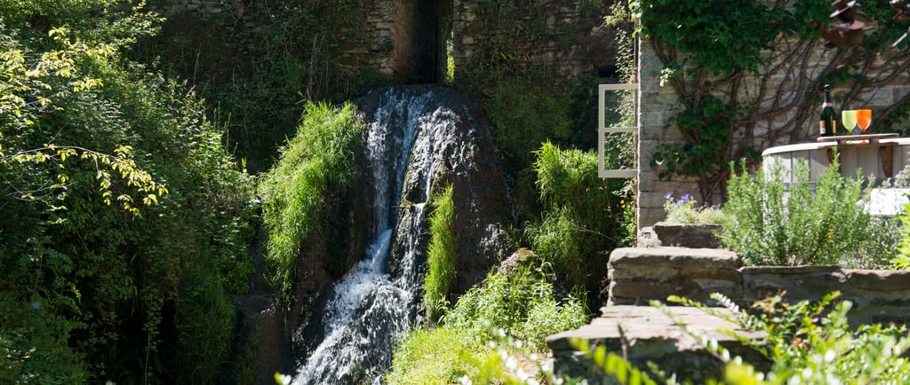 Waterfall beside Mill Cottage at Hanley Mill in the Teme Valley, peaceful countryside retreat.