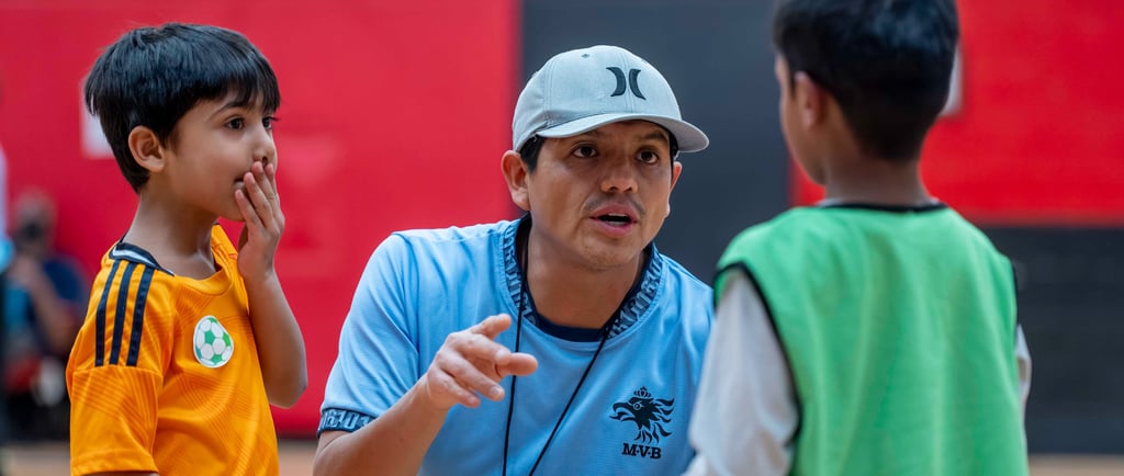 MVB F.C. soccer coach instructing young players training session in Mississauga Soccer School