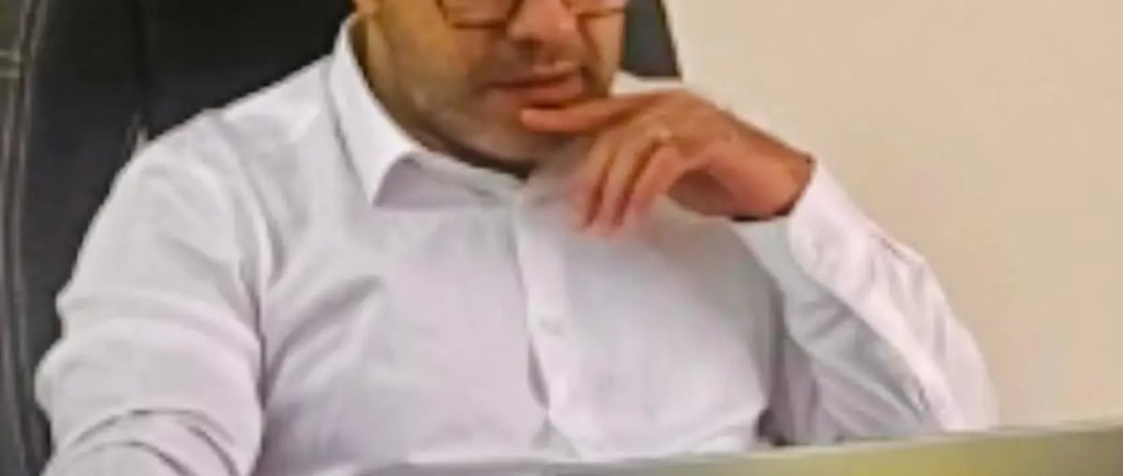 Business owner reviewing SEO website checklist on a laptop in a Croydon office