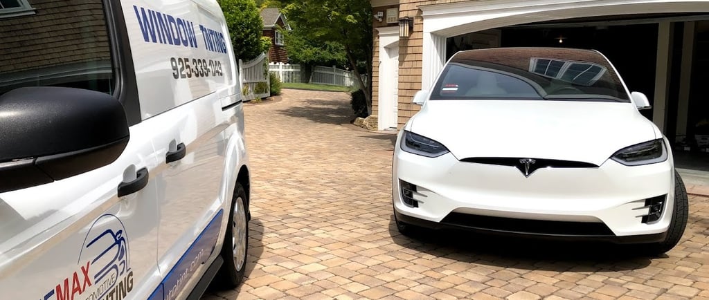 Tesla Model X with 5% Ceramic Window Tint is next to Bluemax Tint mobile service van at a client hom