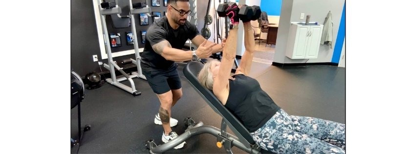 CC Matthews, personal trainer at Trinity Fitness Palm Beach Gardens, coaching a senior client
