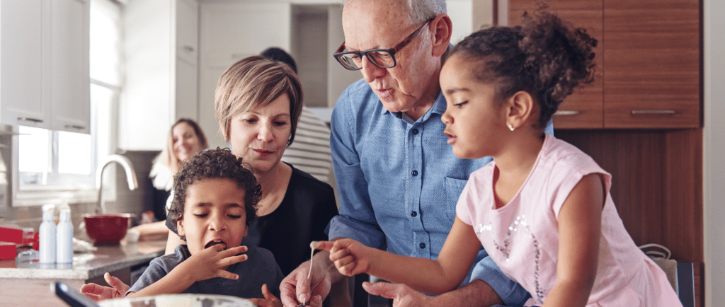 Elders and children cooking together with parents watching